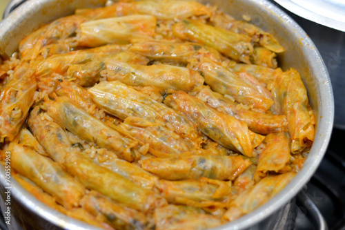 Pile of filled cabbage leaves wrap stuffed Egyptian mahshi and filled with rice, onion, parsley, dill and coriander, selective focus of Arabic Egyptian traditional cuisine of Mahshy ready to be served photo