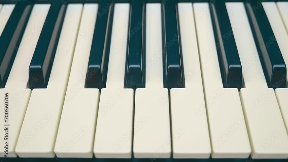 Synthesizer keyboard (piano) as a symbol of music and notes. Shot in motion. Closeup. Macro. Shallow depth of field