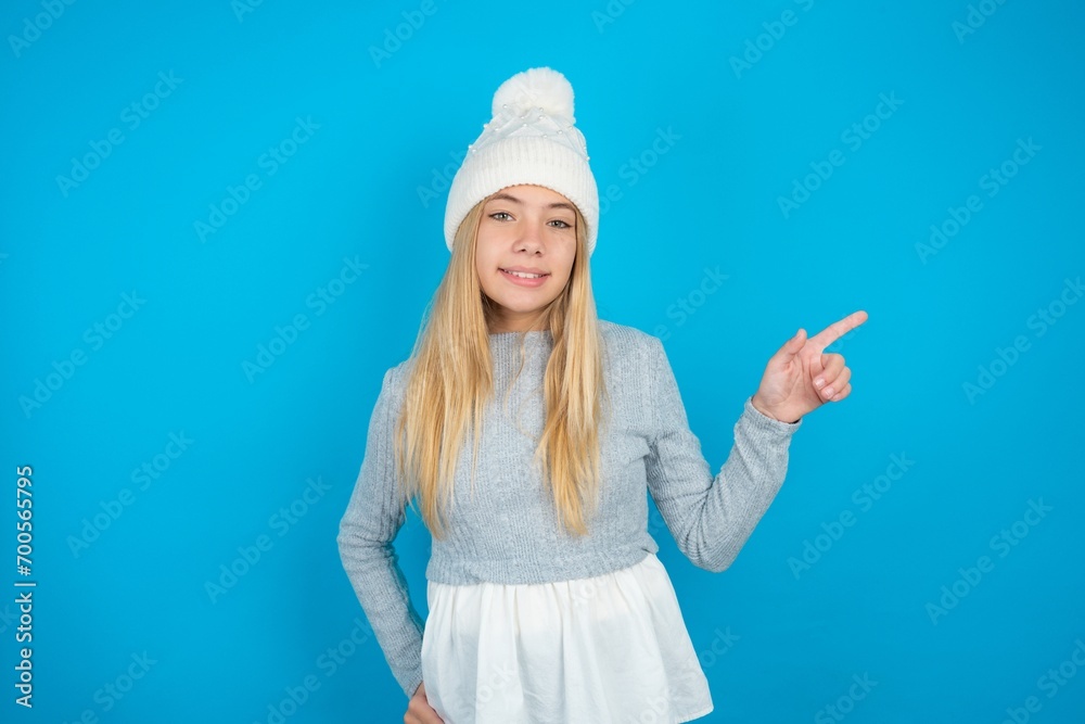 beautiful caucasian teen girl wearing grey sweater looking at camera indicating finger empty space sales beautiful caucasian teen girl wearing grey sweater looking at camera indicating finger empty space sales