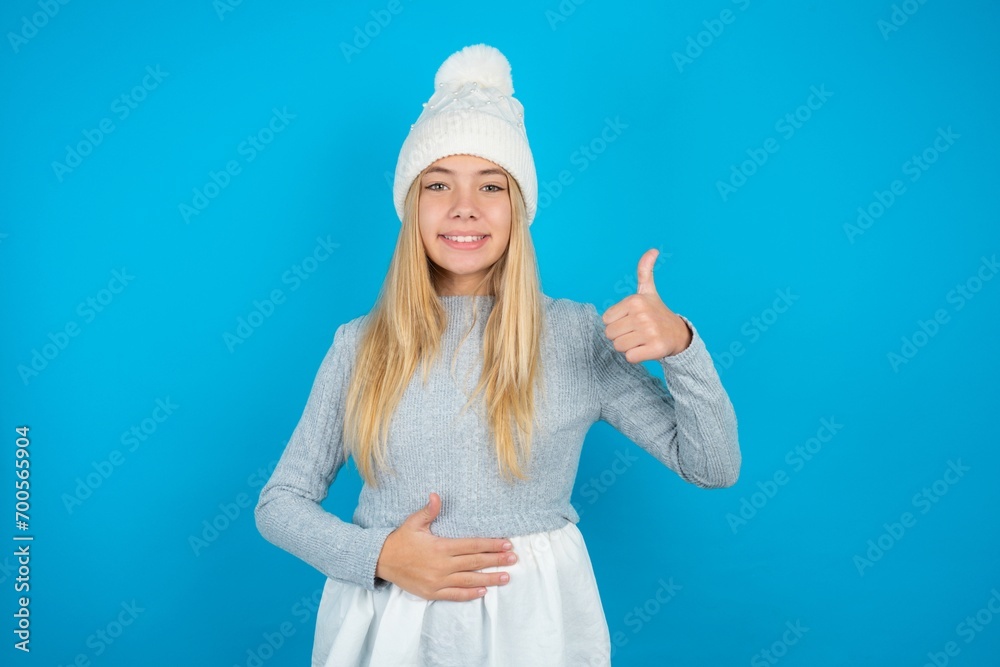 beautiful caucasian teen girl wearing grey sweater happy positive smile hands on belly show thumb-up fine healthy beautiful caucasian teen girl wearing grey sweater happy positive smile hands on belly show thumb-up fine healthy