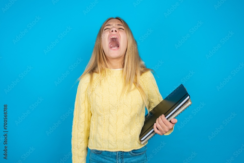 caucasian teen girl angry and mad screaming frustrated and furious, shouting with anger. Rage and aggressive concept. caucasian teen girl angry and mad screaming frustrated and furious, shouting with anger. Rage and aggressive concept.