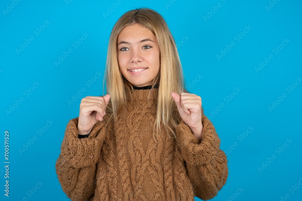 beautiful teen girl clenches fists and awaits for something nice happened looks away bites lips and waits announcement of results beautiful teen girl clenches fists and awaits for something nice happened looks away bites lips and waits announcement of results