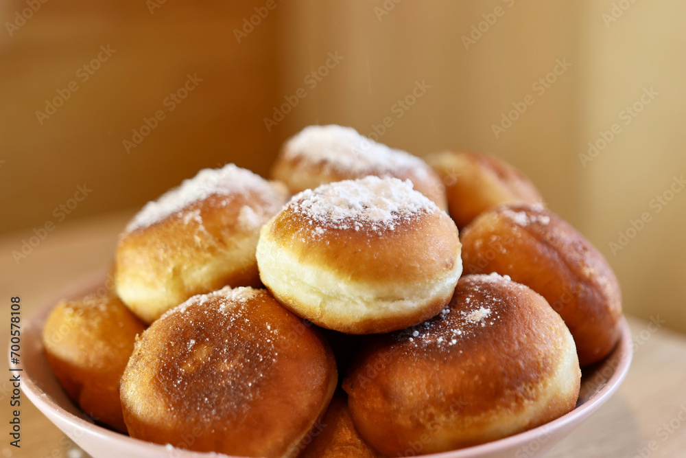 Fresh, ruddy donuts with a sweet filling, sprinkled with sugar.