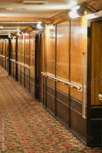 Wooden paneled cabin corridor hallway aisle to staterooms and suites onboard legendary ocean liner cruiseship cruise ship photo