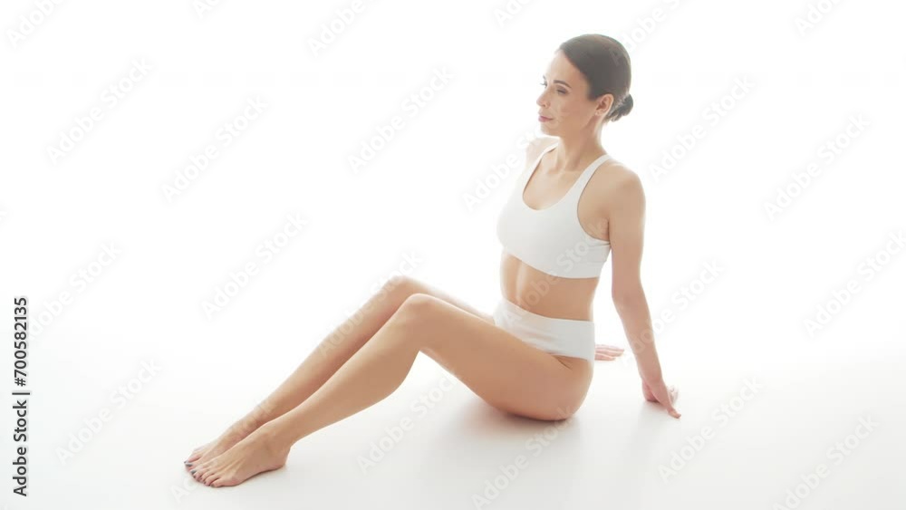 Beautiful woman in white underwear over isolated white background. Studio video of healthy young girl in swimsuit. Health and skin care, wellness, dieting and cosmetics concept. Beautiful woman in white underwear over isolated white background. Studio video of healthy young girl in swimsuit. Health and skin care, wellness, dieting and cosmetics concept.