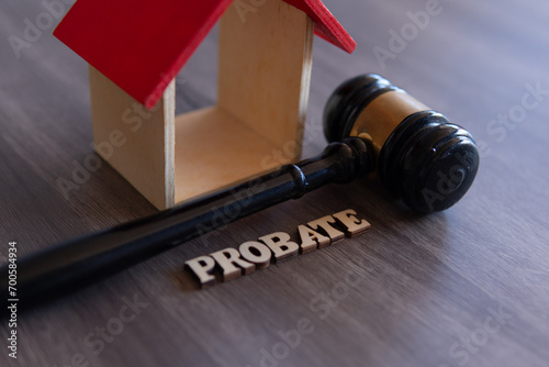 Closeup image of judge gavel, wooden house and word PROBATE. Copy space for text. photo