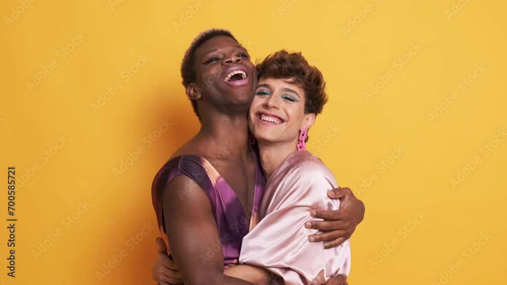 Stylish trans people in make up and fashion clothes embracing and smiling Stylish trans people in make up and fashion clothes embracing and smiling