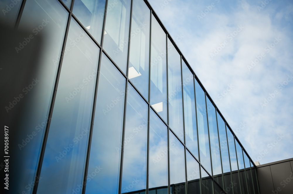 Beautiful glass panels on a business building showing reflections of the sky. Beautiful glass panels on a business building showing reflections of the sky.
