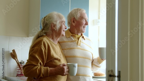 Happy senior couple drinking coffee or tea on home kitchen © Yakobchuk Olena