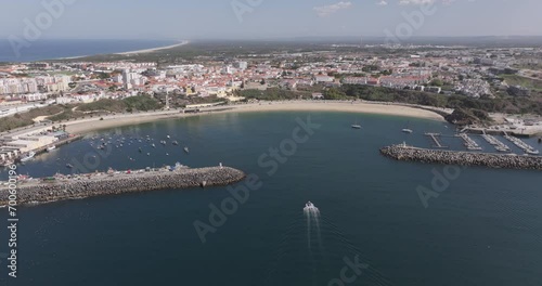 Aerial drone shot of boat coming into port at Praia Vasco da Gama in Sines, Setúbal, Alentejo, Portugal, Europe. Shot in 5K ProRes 422HQ, exported in ProRes photo
