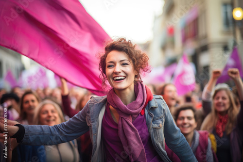 Joyful woman at a rally with a sea of pink flags