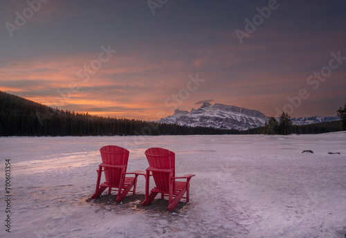 Winter view of a red chairs and Mount Rundle at Two Jack Lake in Banff National Park, Alberta, Canada photo
