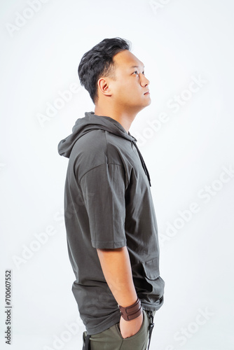 photo shoot of a Korean guy on a white background. A Korean model in a fashionable summer T-shirt. photo shoot of youth clothes with a model in a photo studio