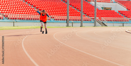 Asian para-athlete runner prosthetic leg on the track alone outside on a stadium track Paralympic running concept.