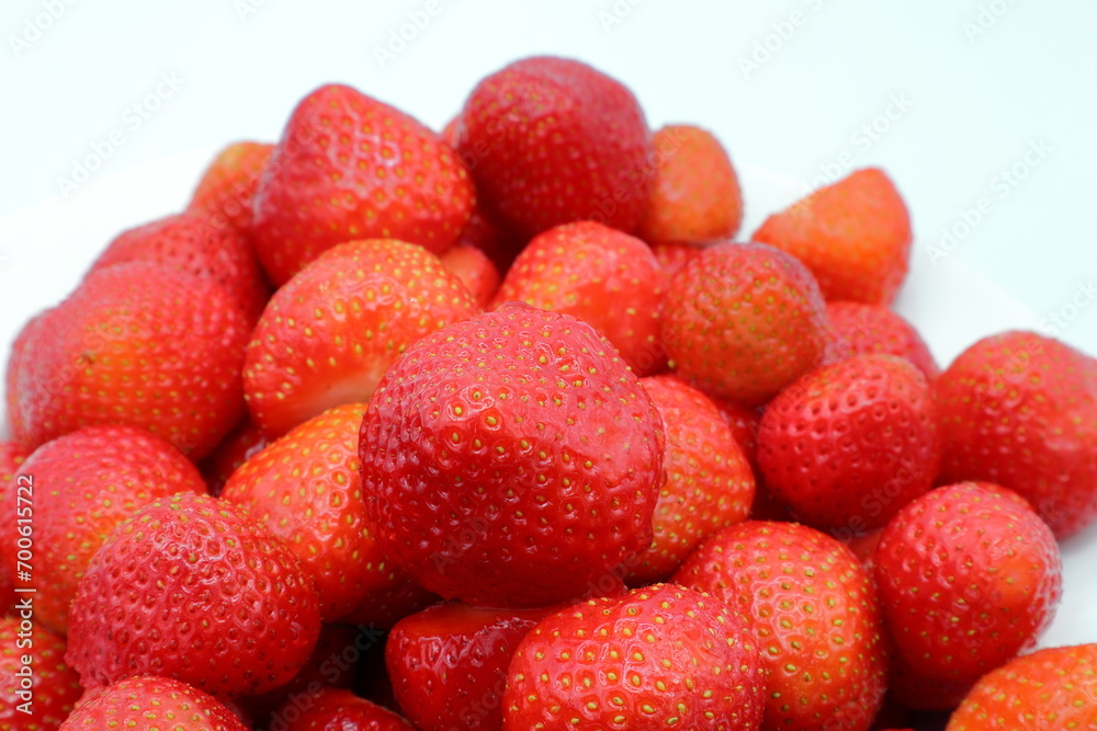 Red juicy strawberries. White plate or background. Red juicy strawberries. White plate or background.