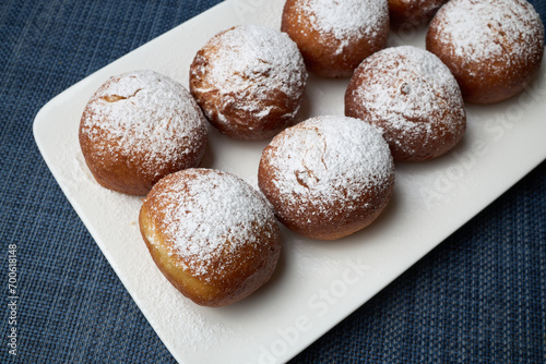 Sweet donuts sprinkled with powdered sugar