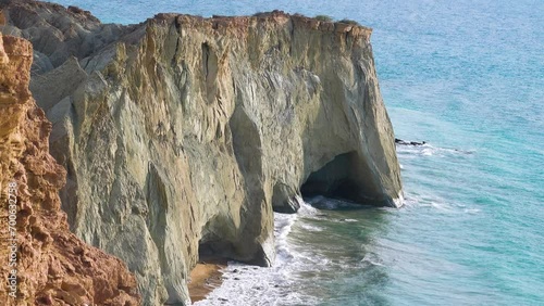 Seascape. Rocky steep coast with grottoes. Island of Hormuz, Strait of Ormuz photo