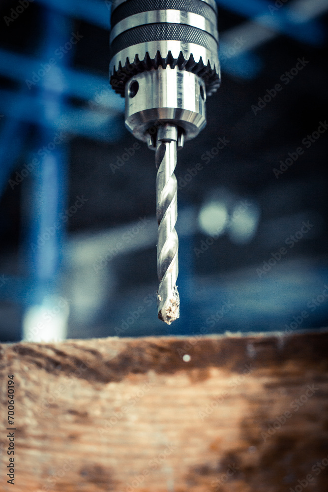 Drilling machine in the workshop, working with a drill