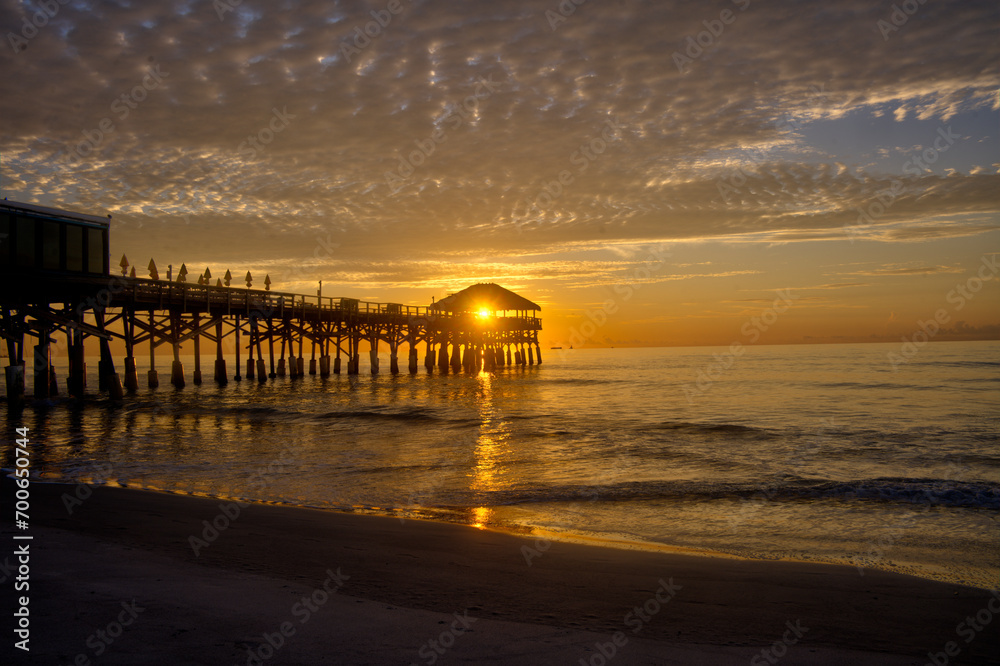 Sun rising behind the hut on the end of the pier at Cocoa Beach