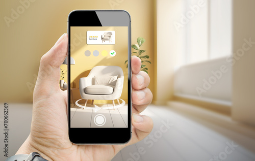 augmented reality for smart Business furniture interior design concept.Man hands holding mobile phone on blurred living room as background photo