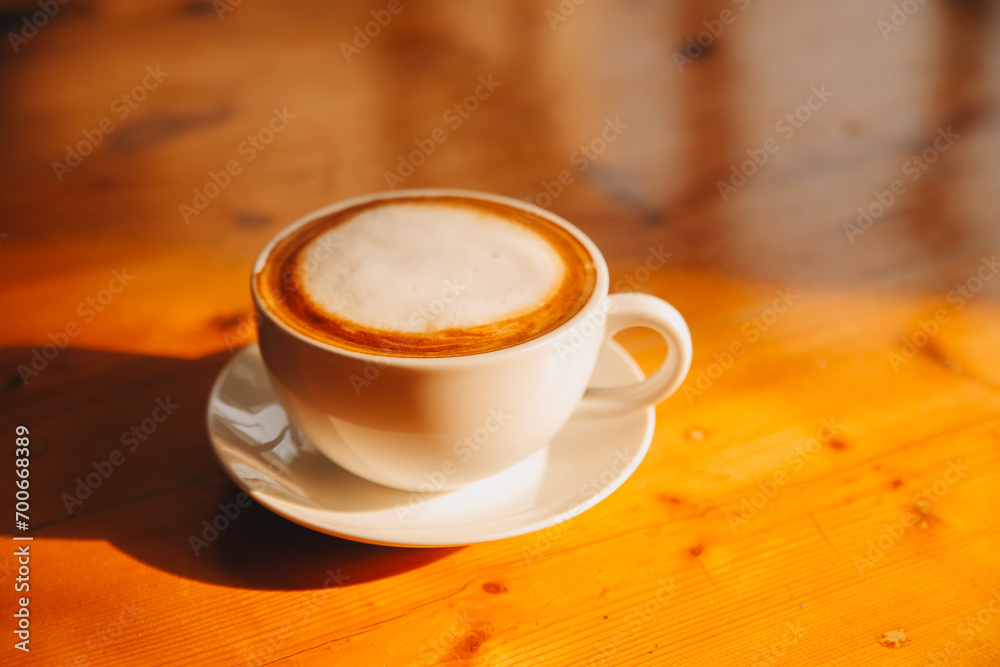Coffee in white cup on wooden table, with spoon. Coffee in white cup on wooden table, with spoon.