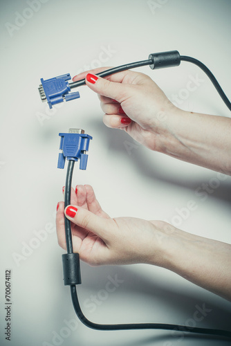 Video connector for a computer in the hands of a girl, connecting to a computer
