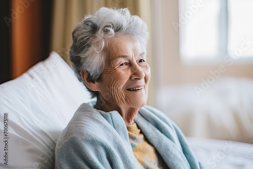A relaxed and happy retired senior woman receiving treatment in a hospital room.