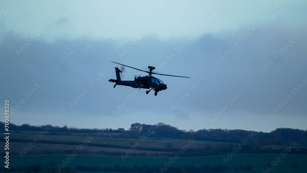 British army Boeing Apache Attack helicopter gunship (AH64E AH-64E ArmyAir606) in low level flight, Wiltshire UK