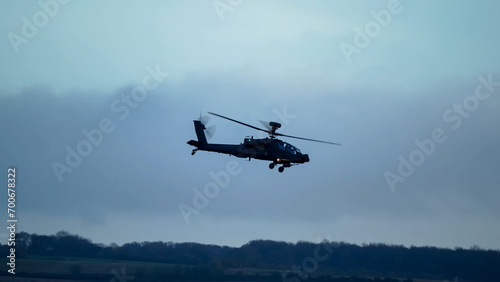 British army Boeing Apache Attack helicopter gunship (AH64E AH-64E ArmyAir606) in low level flight, Wiltshire UK