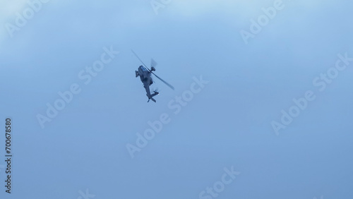 British army Boeing Apache Attack helicopter gunship (AH64E AH-64E ArmyAir606) banking hard in flight, Wiltshire UK