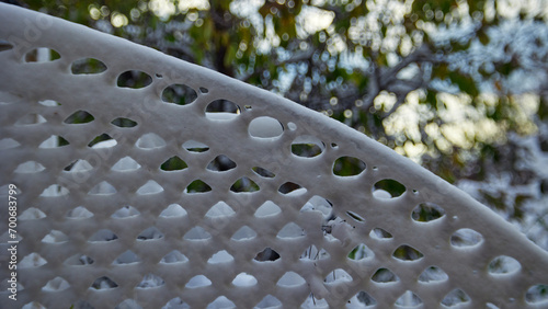 Horizontal pattern background of snow patterns on a metal grid with green foliage on. the background photo