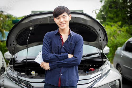 Claim inspector examines outdoor road accident car with form And show friendly and bright smiles throughout the service to customers. © วัชรา กำเหนิด