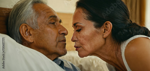 Senior man with gray hair and childbearing dark skin color and older Asian or Arabic woman, depressed sad and listless mood, wrinkles on face, unhappy married for life, intimacy in bedroom photo