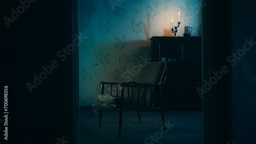 Empty armchair of passed away person standing in haunted house, dolly shot photo