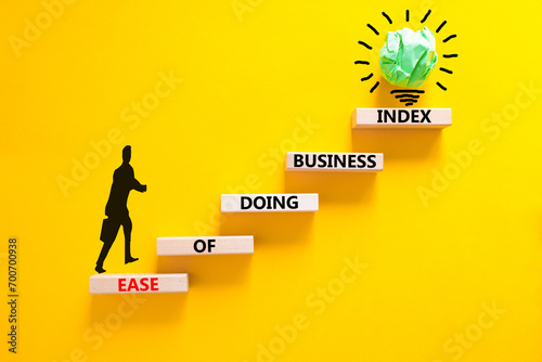 Ease of doing business index symbol. Concept words Ease of doing business index on wooden blocks. Beautiful yellow table yellow background. Business, ease of doing business index concept. Copy space.