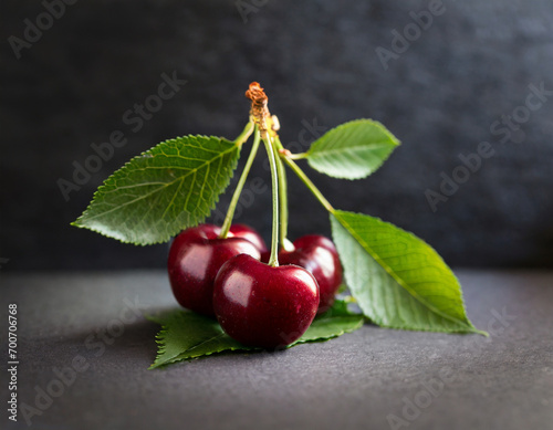 cherry with leaf on dark background, natural
