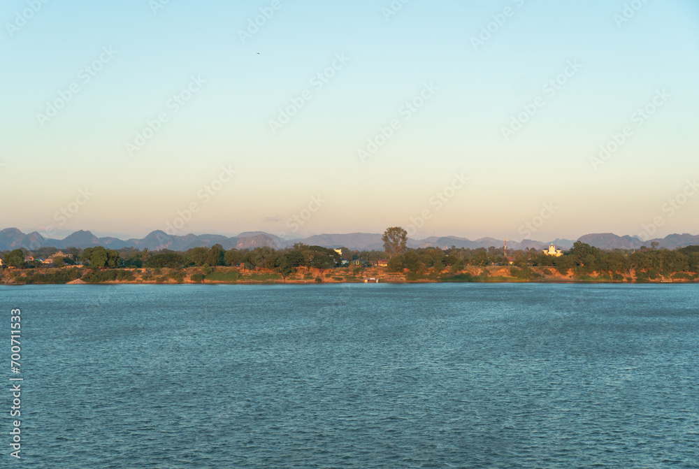 Twilight at Mekong River. The scenery in the morning of Laos along Mekong river with mountains, small villages and forest, Landscape of riverside between Thai and Laos border, Nakhon Phanom, Thailand