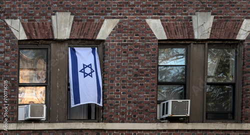 Photography israeli flag hanging in the window of an apartment building in brooklyn, new yor