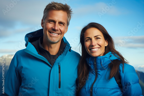 Radiant Couple Against Blue Sky with Mountainous Scene
