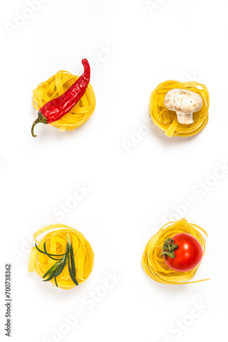 Fototapeta Naklejka Na Ścianę i Meble -  Raw pasta with vegetables and spices on white background