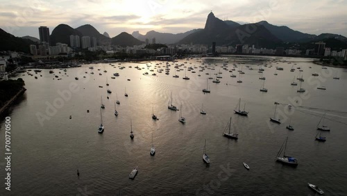 Aerial drone approaching Botafogo Bay in Rio de Janeiro, Brazil at sunset with iconic Christ the Redeemer Statue visible - UNESCO World Heritage Site photo