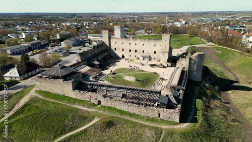 Captivating aerial view of Rakvere's hilltop ruined castle in Estonia. Detailed exterior shot showcases the medieval charm of Rakvere Castle. photo
