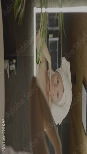 Caucasian female in her 40s is making her daily skin care routine