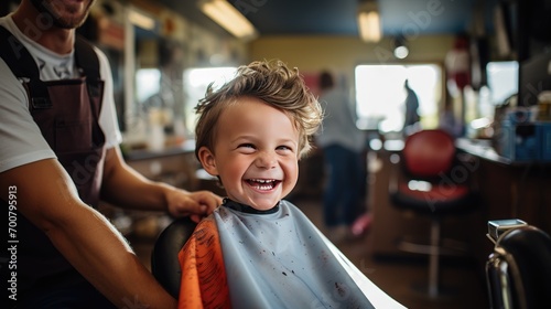 boy at haidresser salon getting haircut sitting in chair