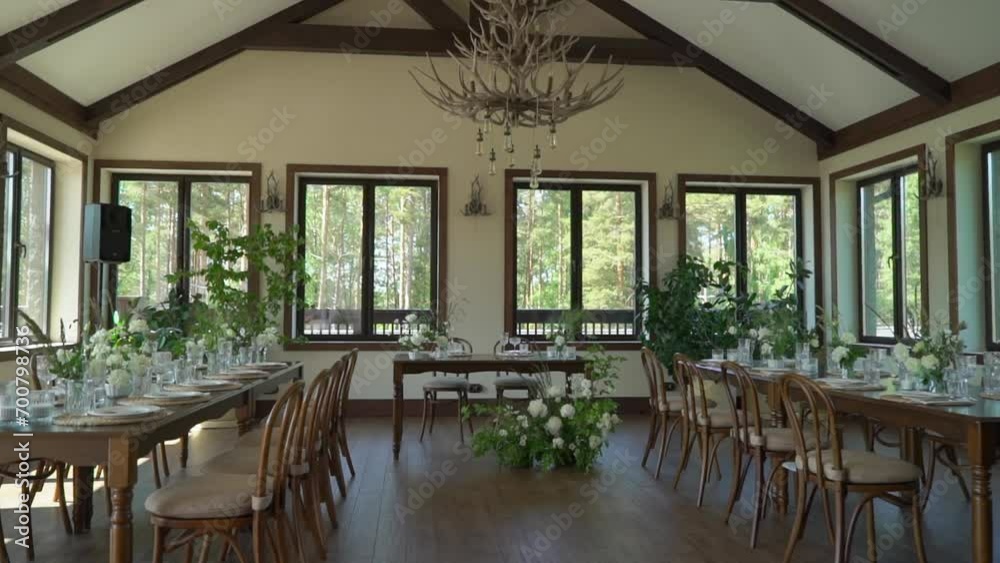 A Beautifully Decorated Wedding Reception Venue. A room with tables and chairs, flower decoration. Luxury event.