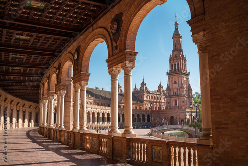 The Plaza de España galleries lited up with evening sunlight making magic shadows. North tower view on Spain Square, Andalusia, South Spain. photo