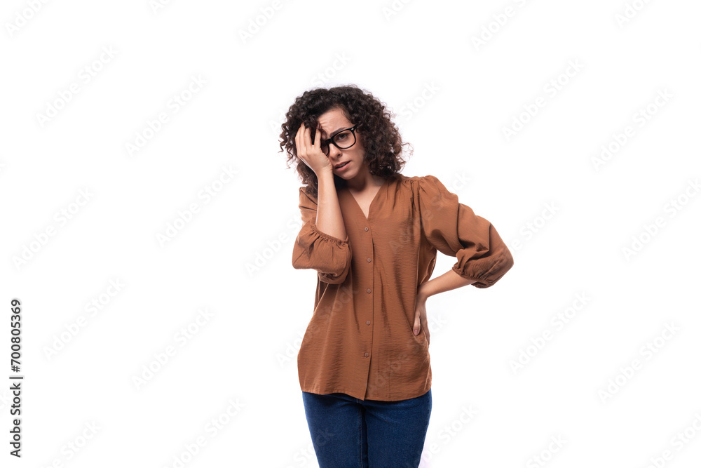 young smart slender woman with a curly haircut is dressed in a brown blouse young smart slender woman with a curly haircut is dressed in a brown blouse