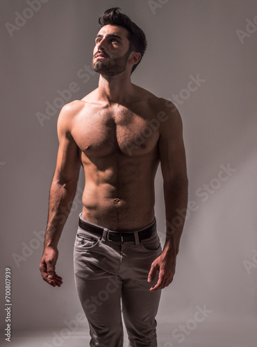 Photo of a shirtless man posing for a photo
