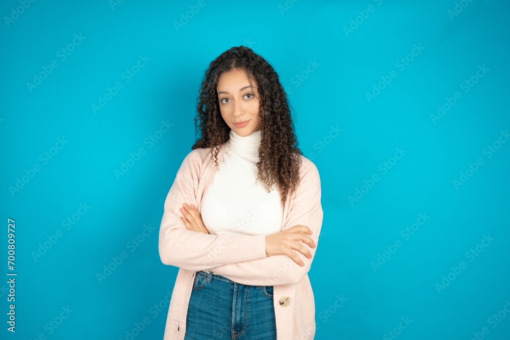 Young beautiful teen woman happy face smiling with crossed arms looking at the camera. Positive person. Young beautiful teen woman happy face smiling with crossed arms looking at the camera. Positive person.