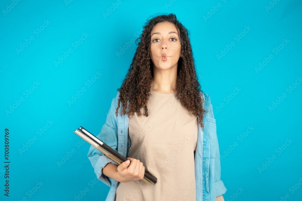 Young beautiful teen woman making fish face with lips, crazy and comical gesture. Funny expression. Young beautiful teen woman making fish face with lips, crazy and comical gesture. Funny expression.